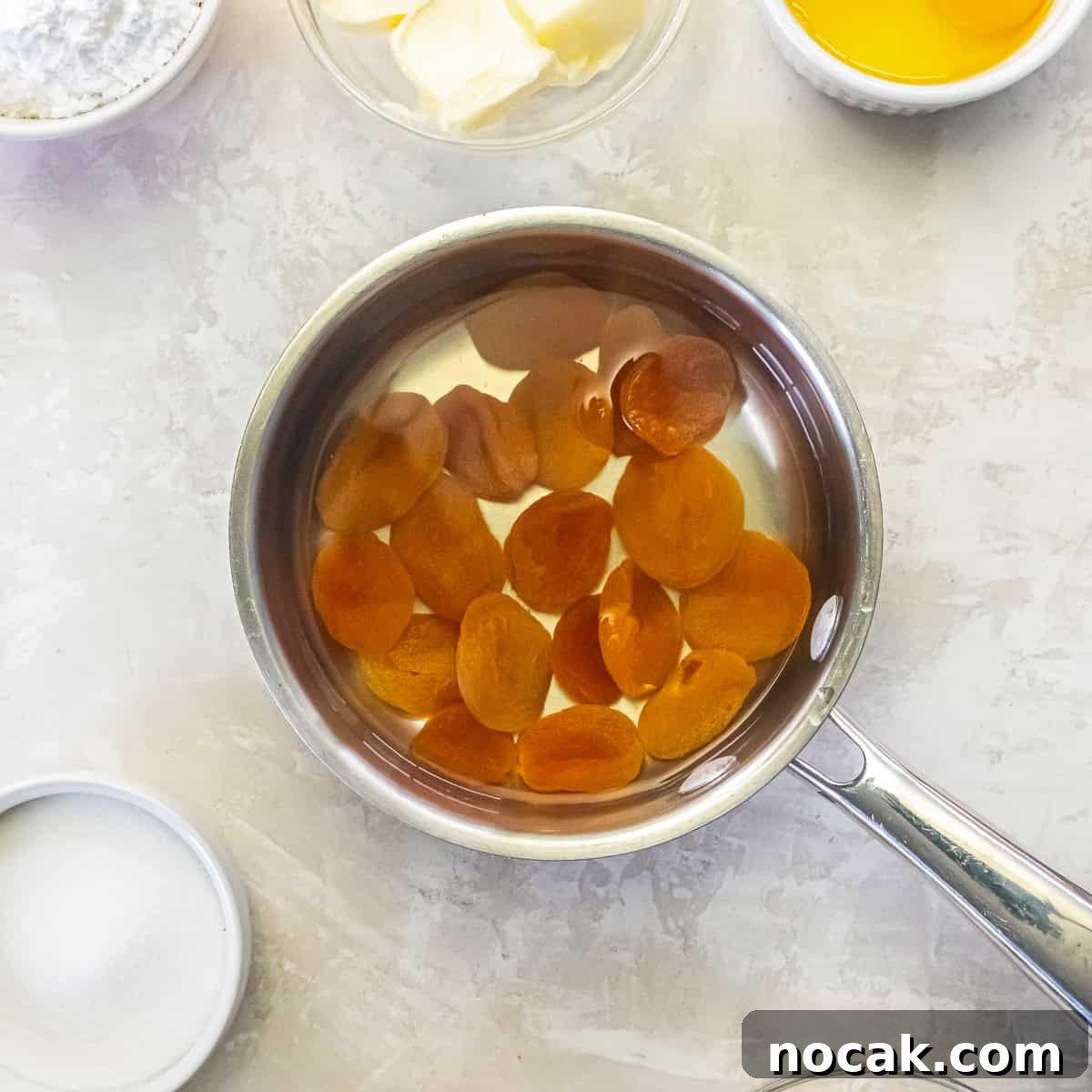 Chewy Apricot Bars with Oat Crust and Almond Glaze 6 Dried apricots simmering in water to soften before chopping.