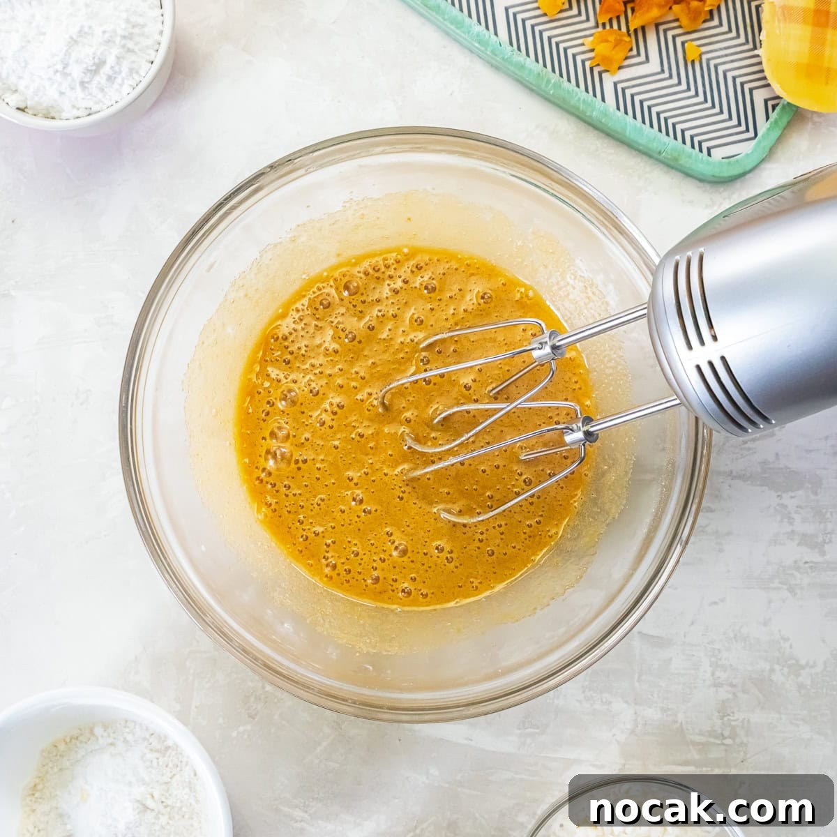 Chewy Apricot Bars with Oat Crust and Almond Glaze 9 Eggs, brown sugar, and vanilla being mixed with an electric hand mixer.
