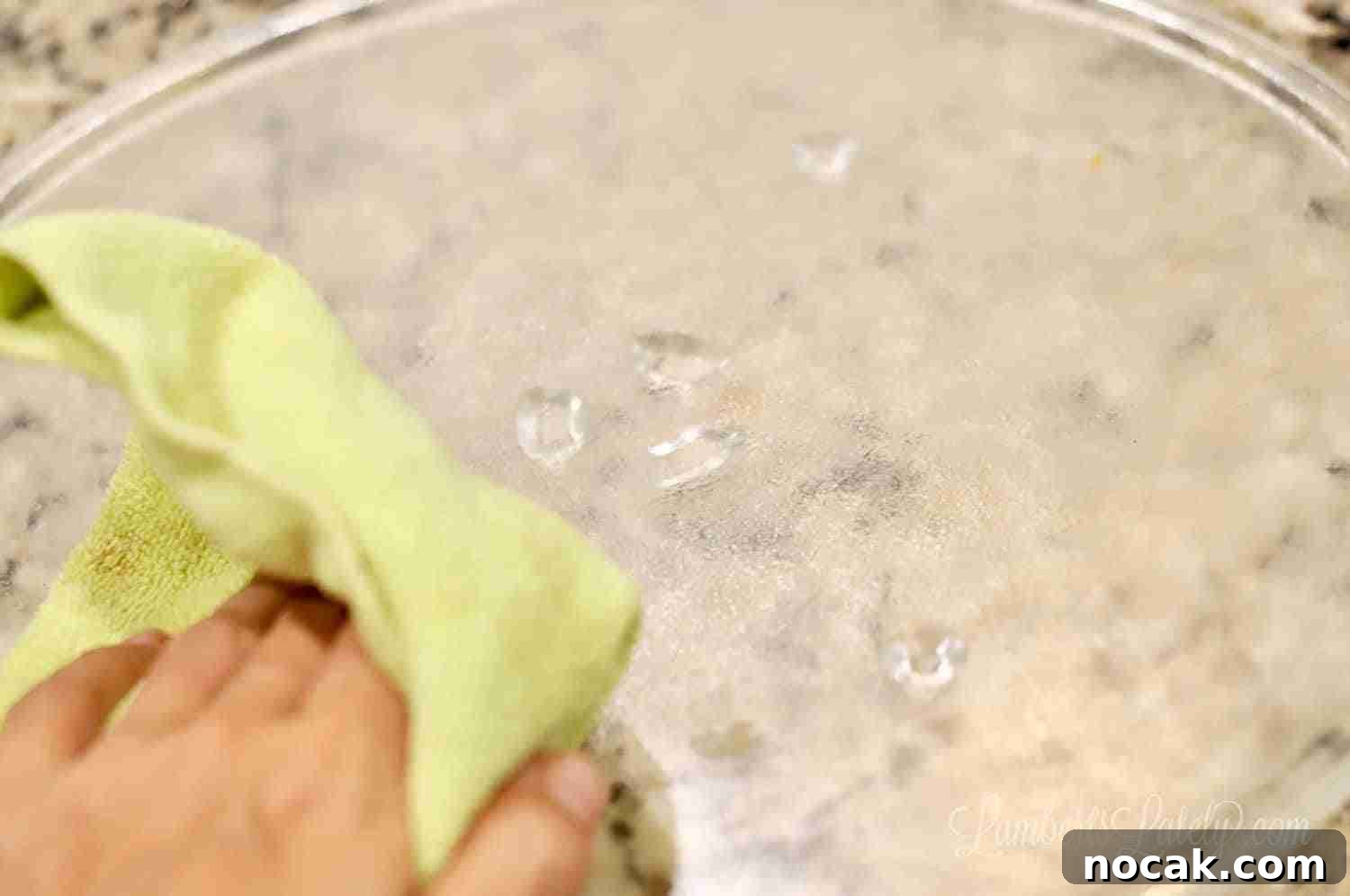 Clean Your Microwave Quickly Using Vinegar and Water 7 cleaning the turntable of a microwave with microfiber cloth