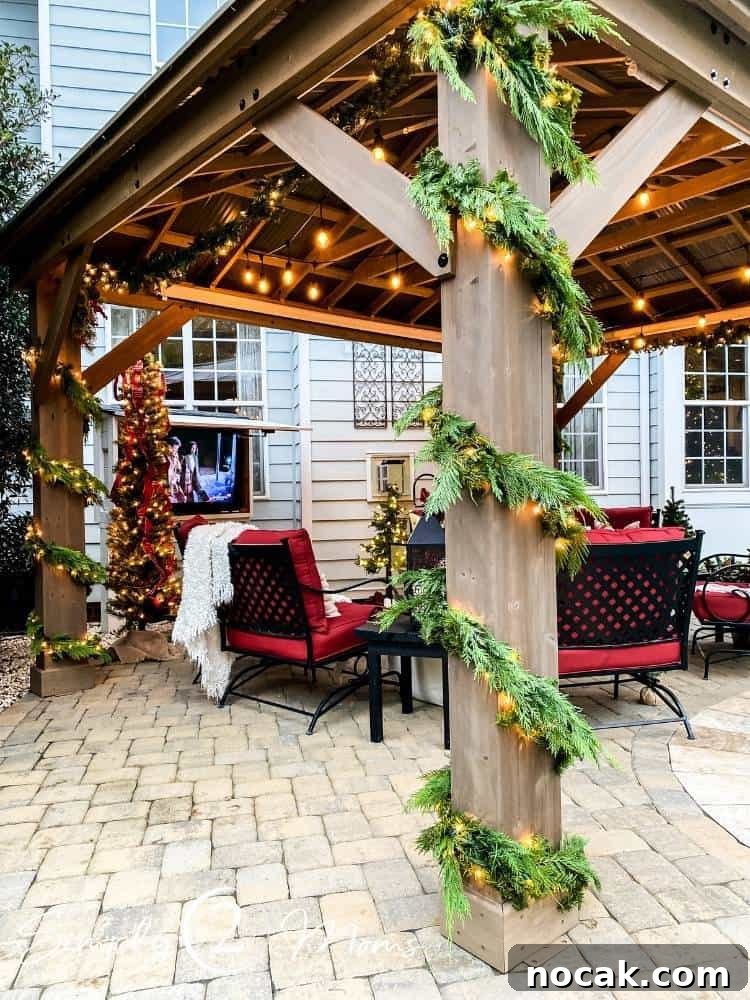 outdoor pergola with six cushioned chairs under pergola with string lights above and greenery wrapped around posts of pergola