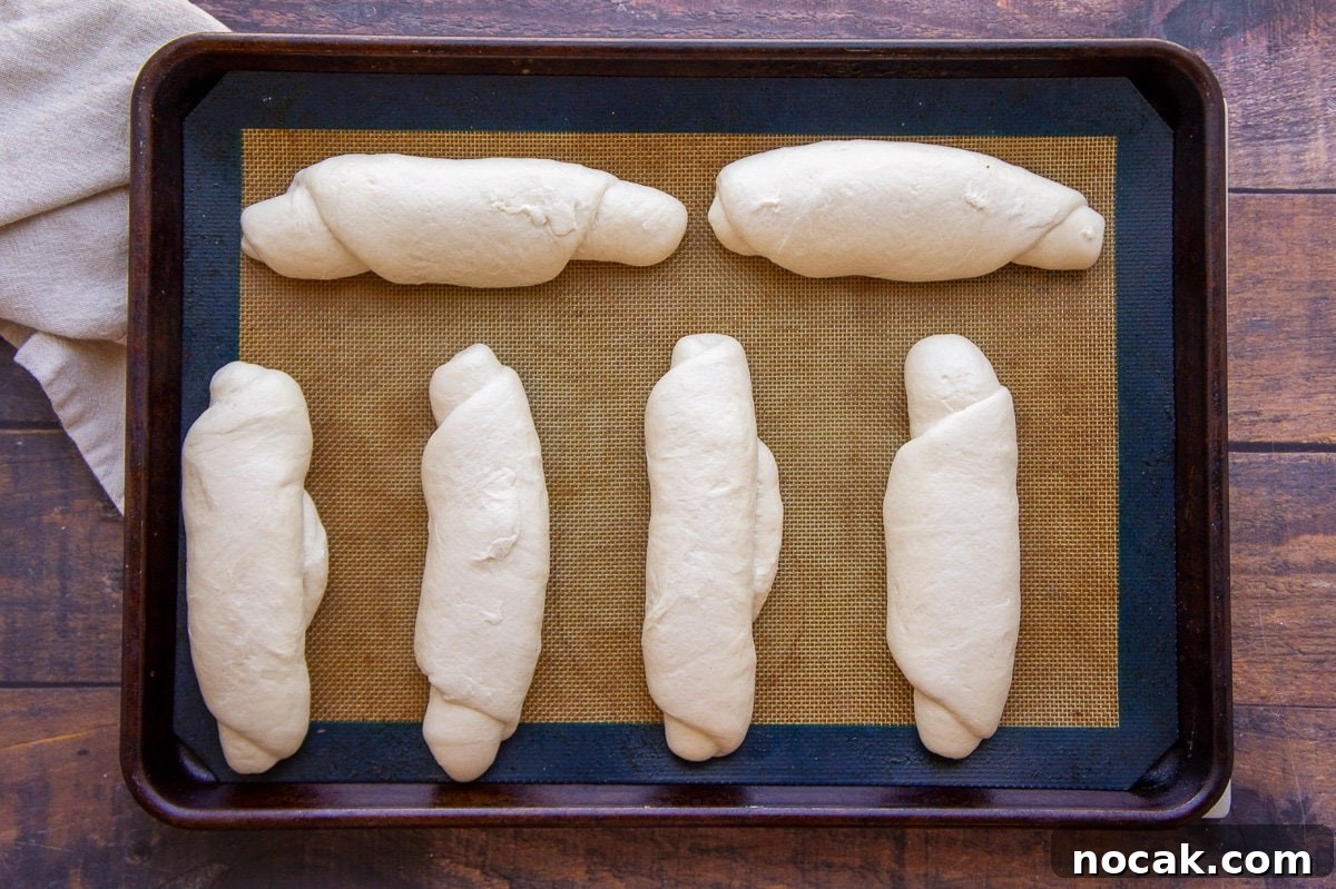 Soft Homemade Hot Dog Buns Recipe for Perfect Sandwiches 4 homemade hot dog buns, shaped on a baking sheet