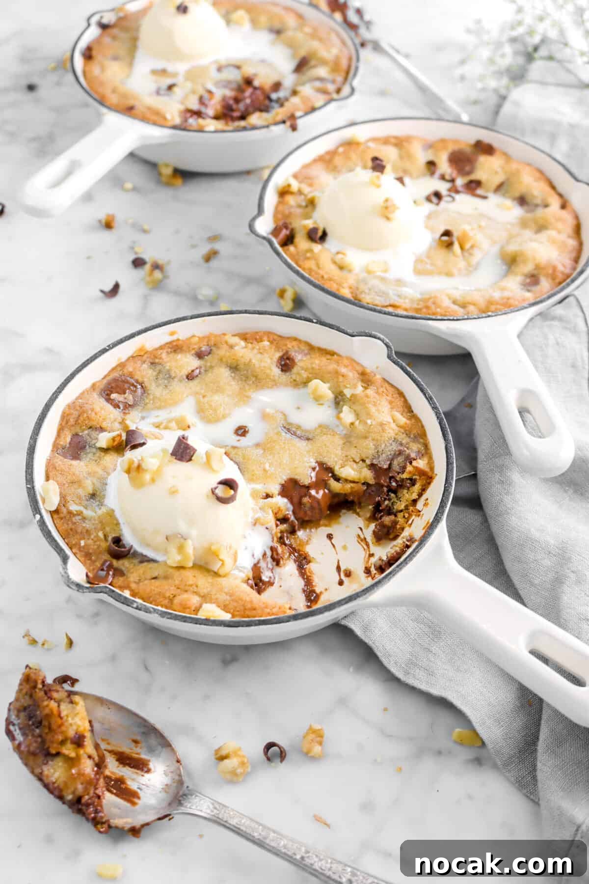 skillet cookies with a spoonful of cookie with ice cream on top