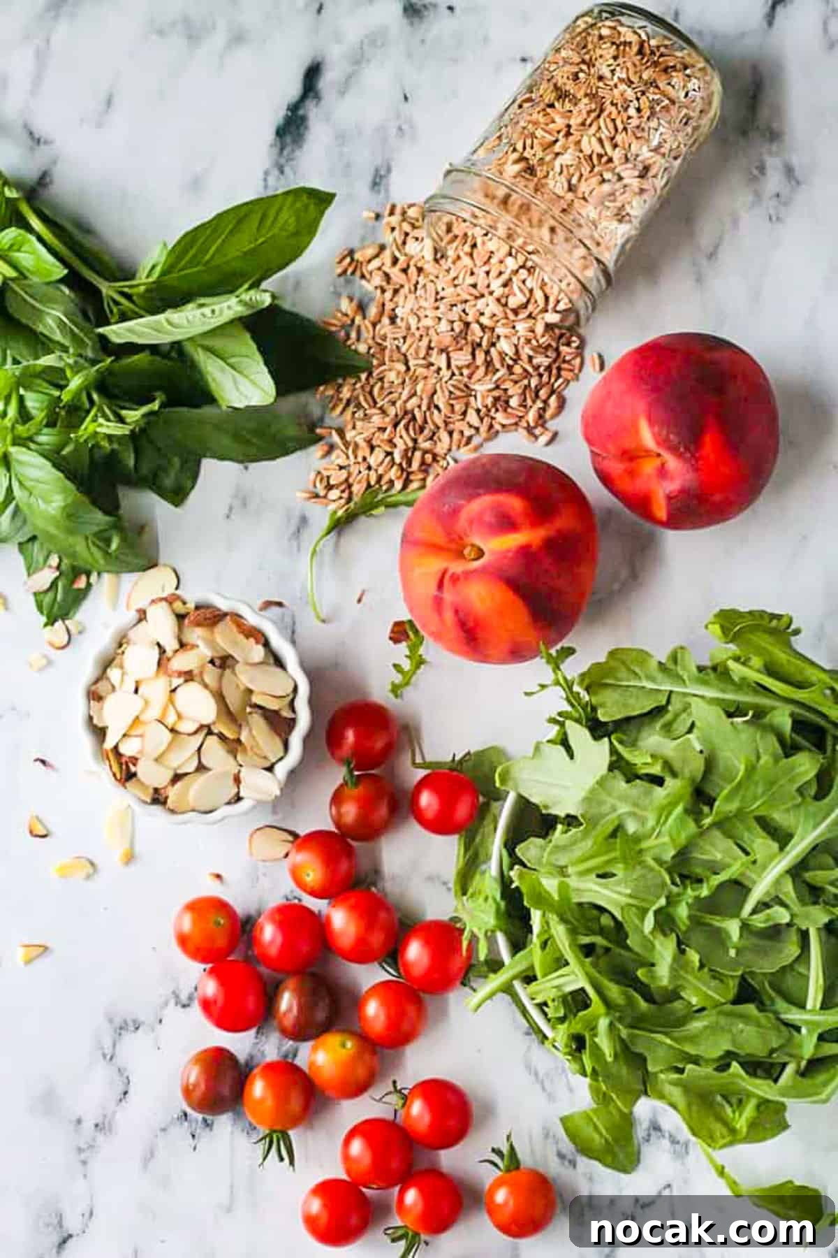 Arugula, Peach & Farro Salad with Orange Vinaigrette 3 Recipe ingredients placed on a table.