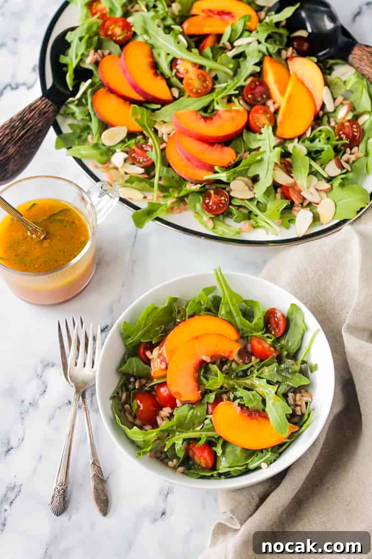 Arugula, Peach & Farro Salad with Orange Vinaigrette 5 Small bowl of salad in front of a large platter of salad.