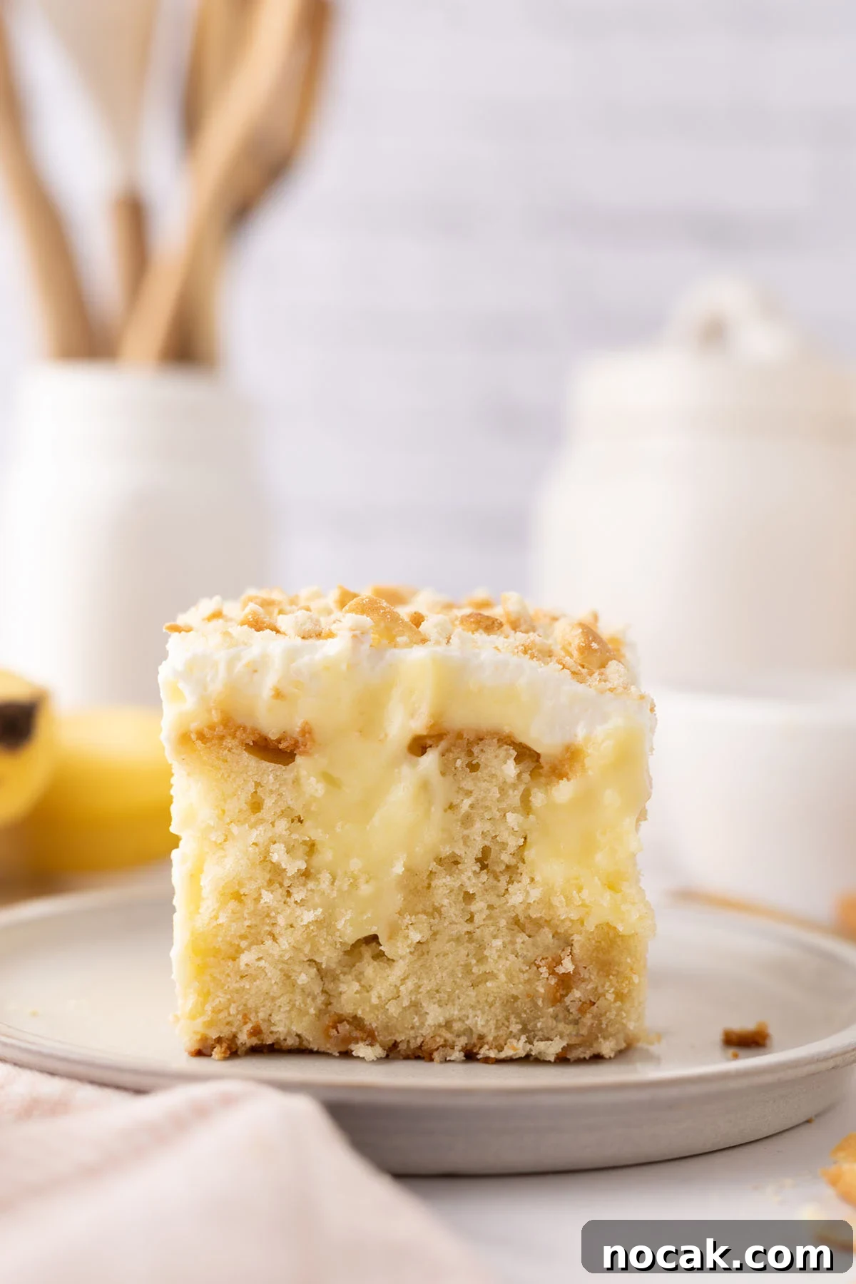 Creamy Banana Pudding Poke Cake Recipe for Dessert Fans 2 Slice of Banana Pudding Poke Cake on a plate.