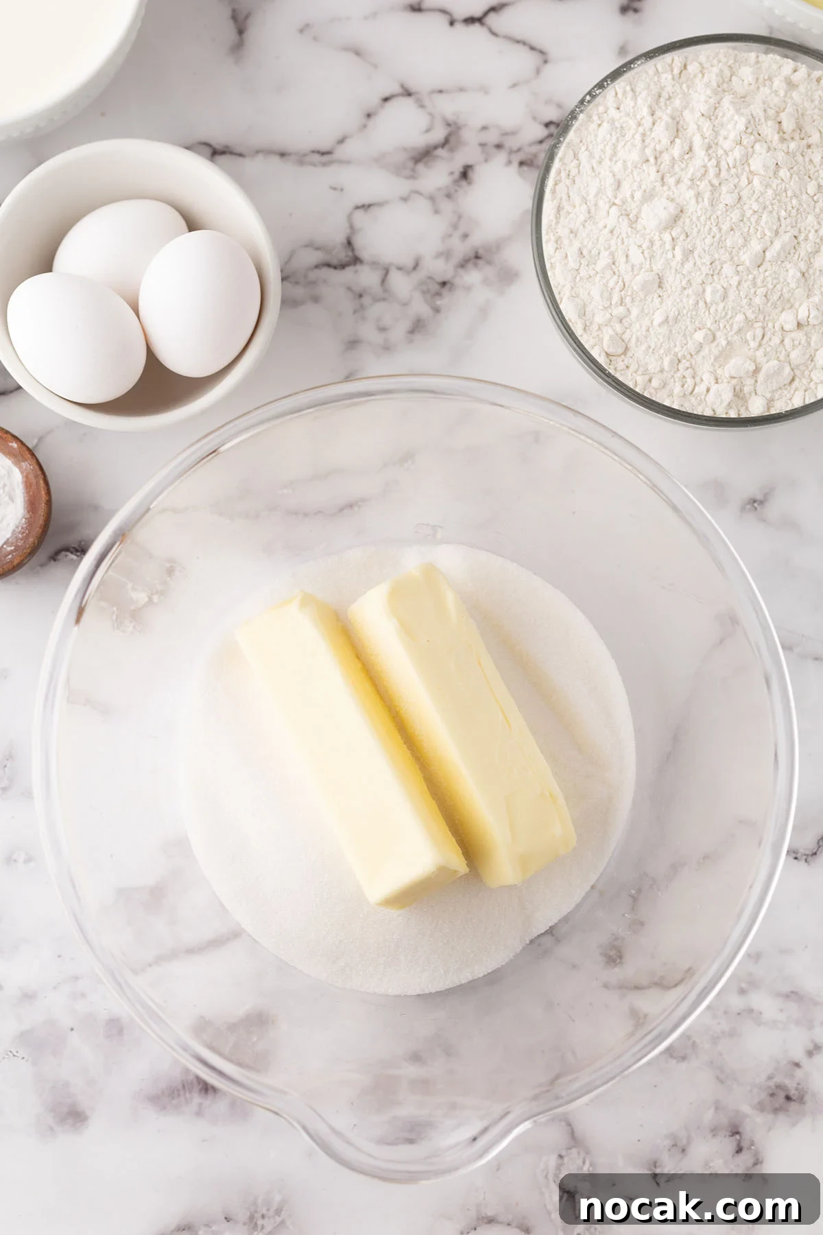 Creamy Banana Pudding Poke Cake Recipe for Dessert Fans 4 Two sticks of butter and sugar in a mixing bowl.