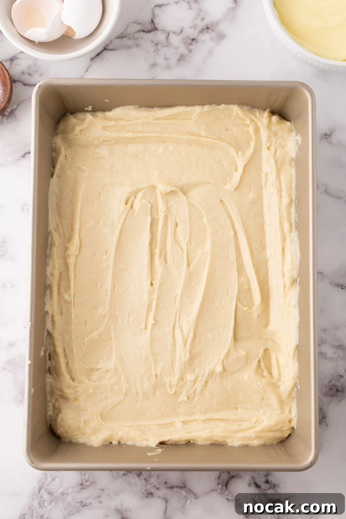Creamy Banana Pudding Poke Cake Recipe for Dessert Fans 7 Cake batter in a baking pan.