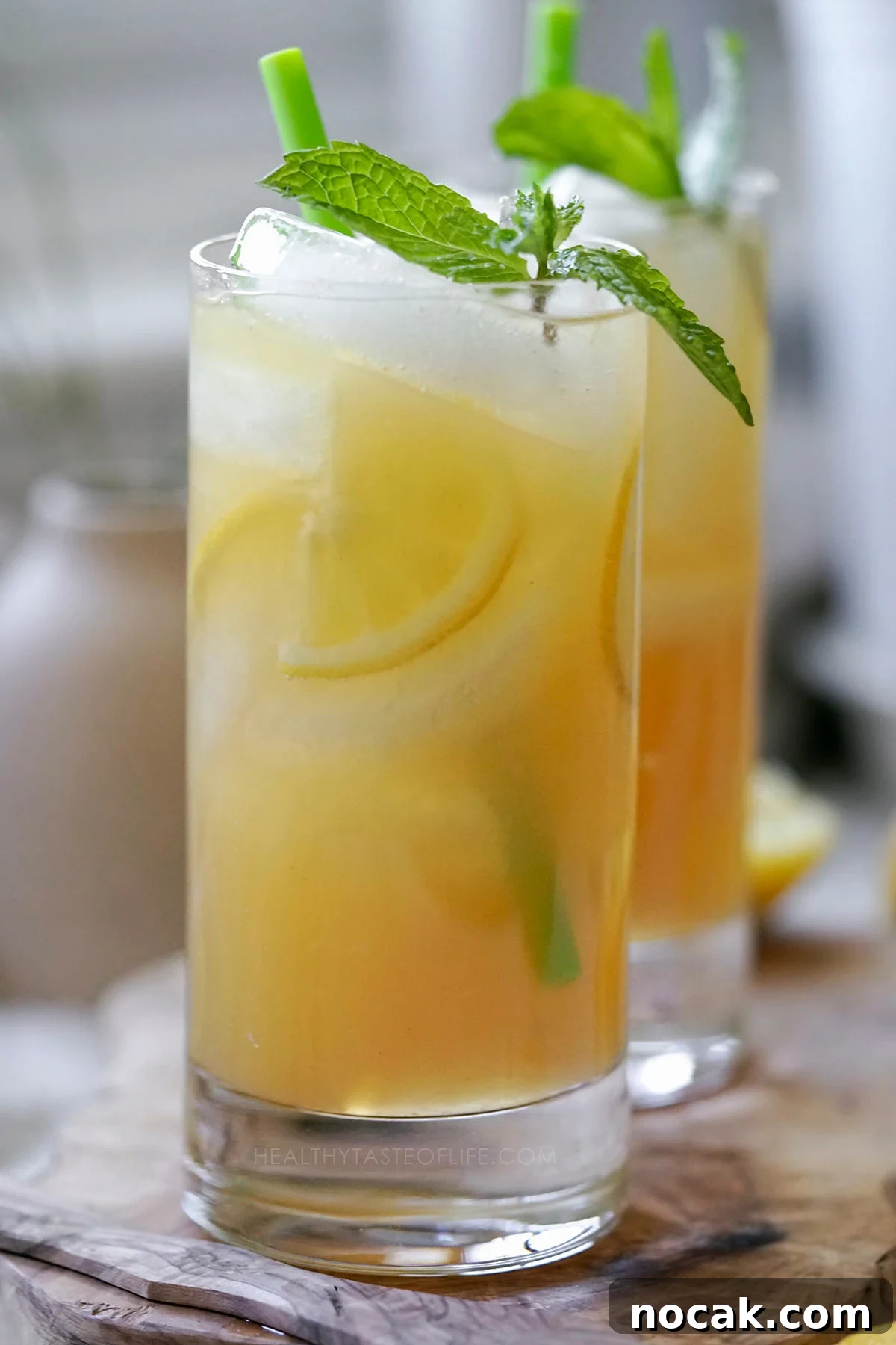 Refreshing Green Tea Lemonade with Fresh Lemon and Mint 2 Homemade healthier green tea lemonade served in a tall glass with ice and fresh mint.