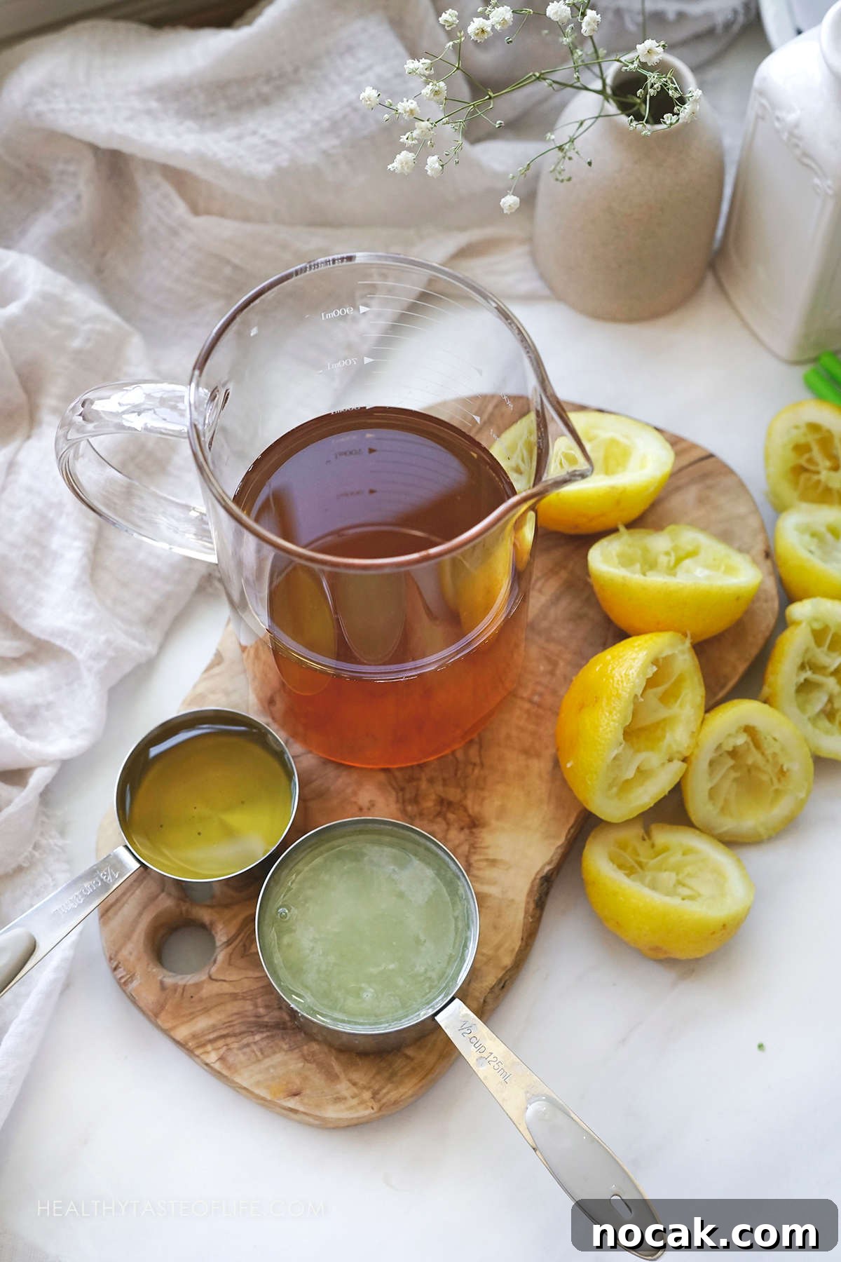 Refreshing Green Tea Lemonade with Fresh Lemon and Mint 3 Picture showing the ingredients needed to make a green tea lemonade at home displaying the measured amounts on a table.