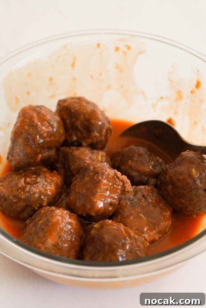 Spicy Firecracker Meatballs with Sweet Chili Glaze 11 process shot - baked beef meatballs tossed with firecracker sauce.