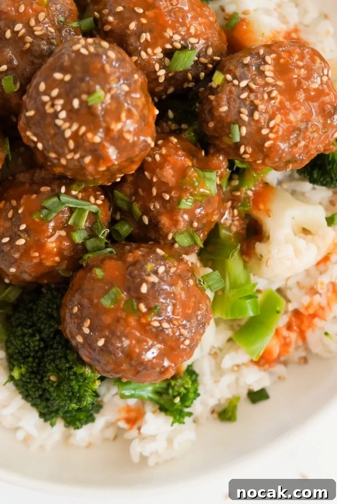 Spicy Firecracker Meatballs with Sweet Chili Glaze 14 overhead shot of beef firecracker meatballs in a white bowl with white rice and steamed broccoli.