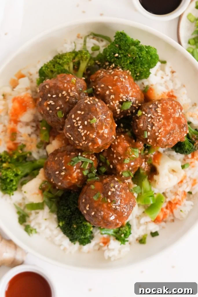 Spicy Firecracker Meatballs with Sweet Chili Glaze 16 overhead shot of a bright and colorful bowl of firecracker beef meatballs with broccoli and rice.