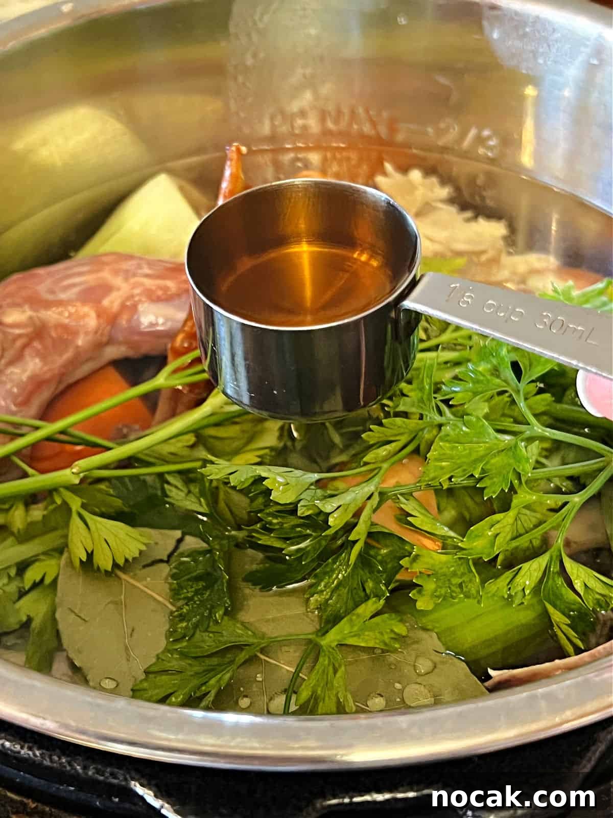 turkey bone broth ingredients in instant pot, adding apple cider vinegar.