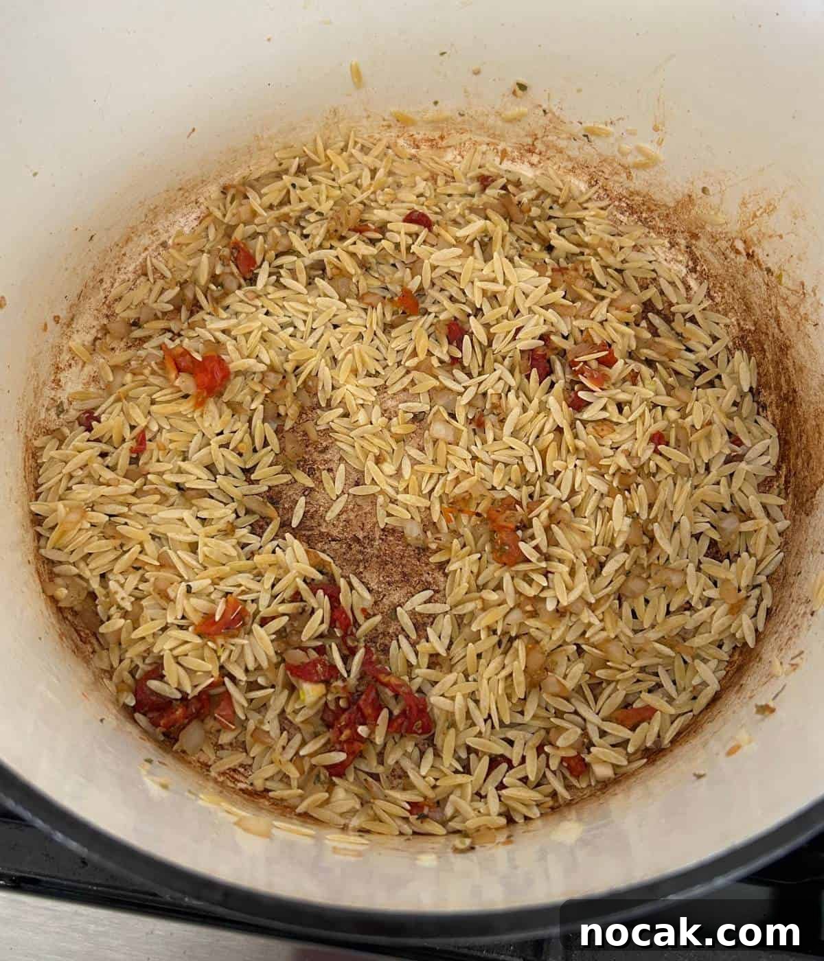 Creamy One-Pot Chicken and Orzo Bake: Comforting Weeknight Meal 8 Orzo toasting in pan.