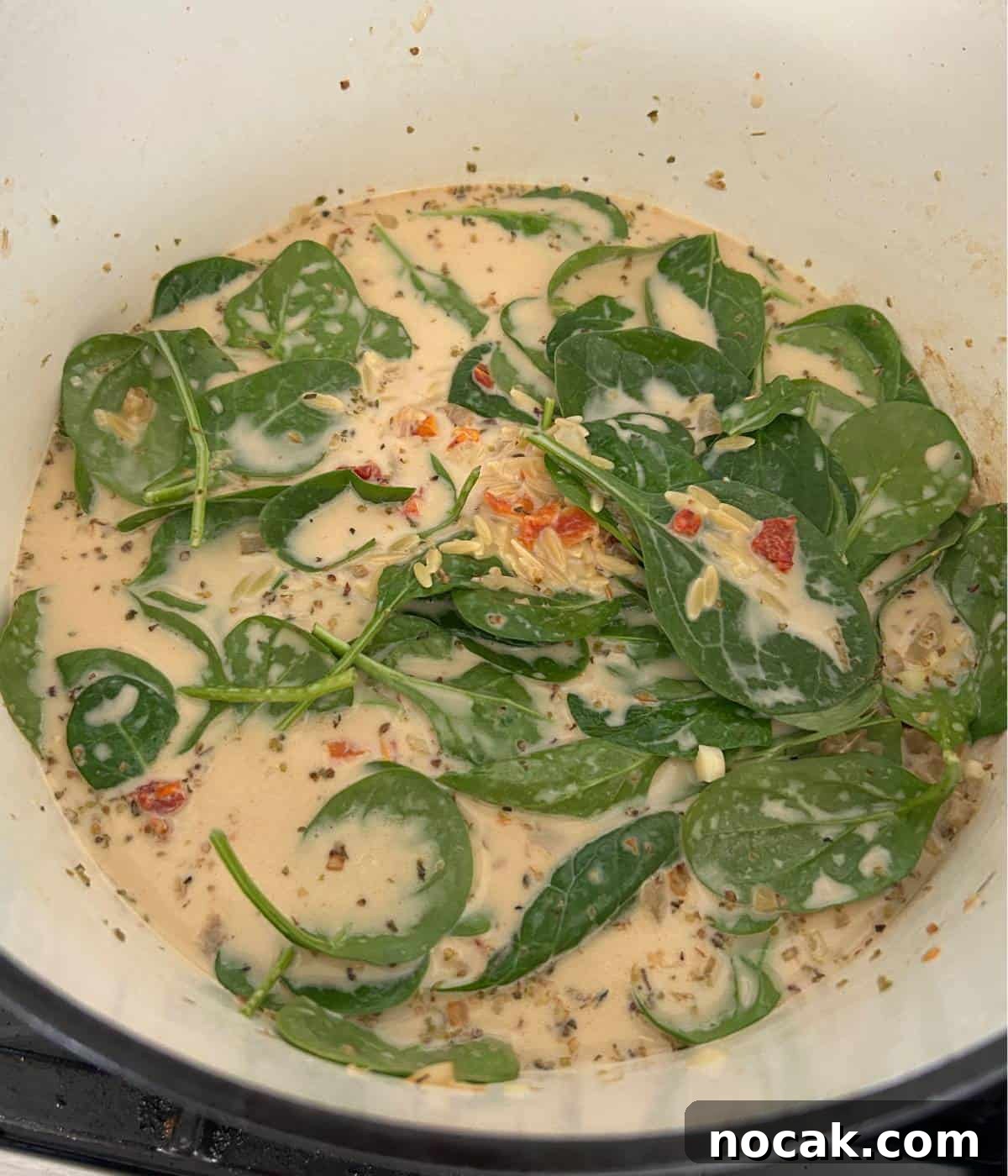 Creamy One-Pot Chicken and Orzo Bake: Comforting Weeknight Meal 9 Orzo and spinach in creamy sauce.