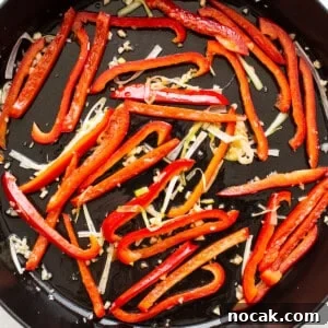Authentic Kung Pao Shrimp Recipe with Crispy Peanuts and Chili 4 veggies in frying pan.