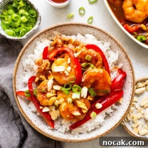 Authentic Kung Pao Shrimp Recipe with Crispy Peanuts and Chili 6 kung pao shrimp with white rice in bowl.