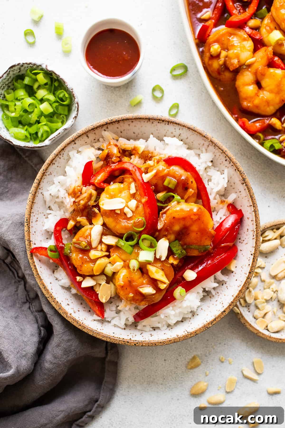 Kung pao shrimp is a 30-minute stir fry recipe that's sweet and spicy. We're serving ours with white rice and bell peppers. kung pao shrimp in bowl.