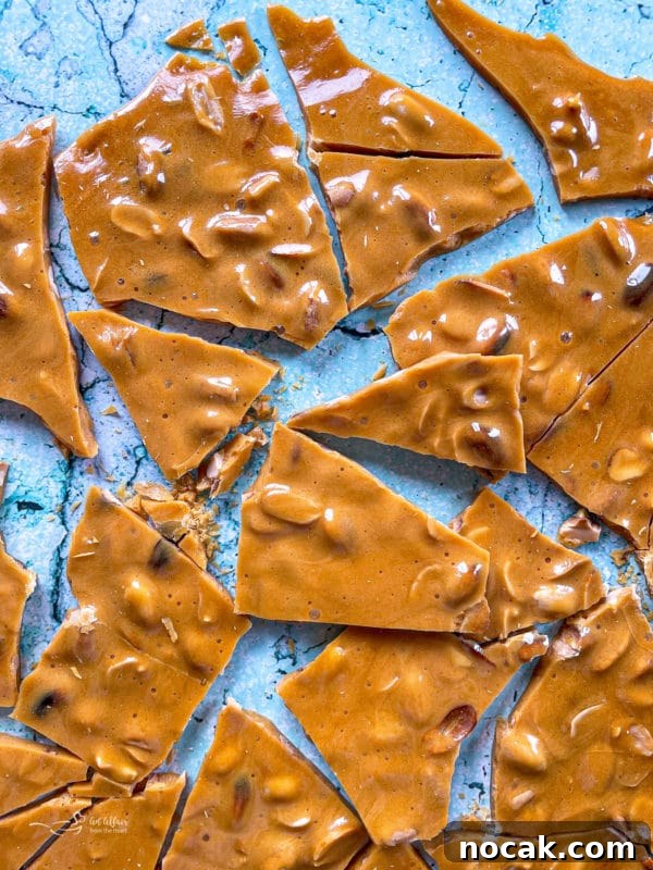 Classic Crunchy Peanut Brittle Recipe for Homemade Candy 8 peanut brittle cracked on a marble surface