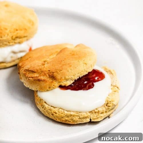 4-Ingredient Protein Scones Made Without Butter 11 Two scones with yoghurt and strawberry jam.