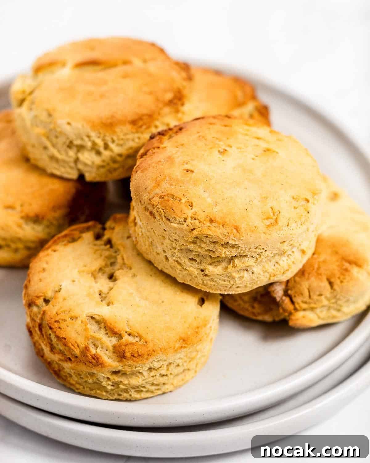 4-Ingredient Protein Scones Made Without Butter 3 A stack of freshly baked scones on a grey plate.