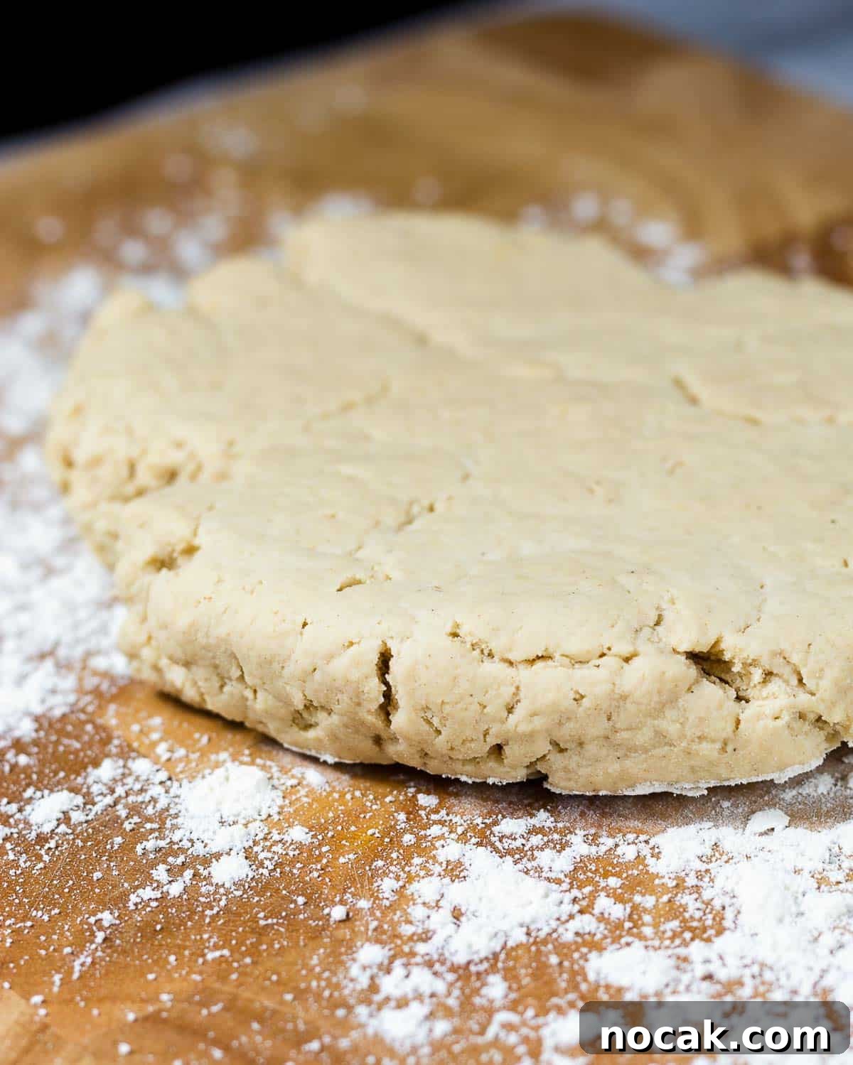 4-Ingredient Protein Scones Made Without Butter 6 Scone dough rolled out on a chopping board dusted with flour.