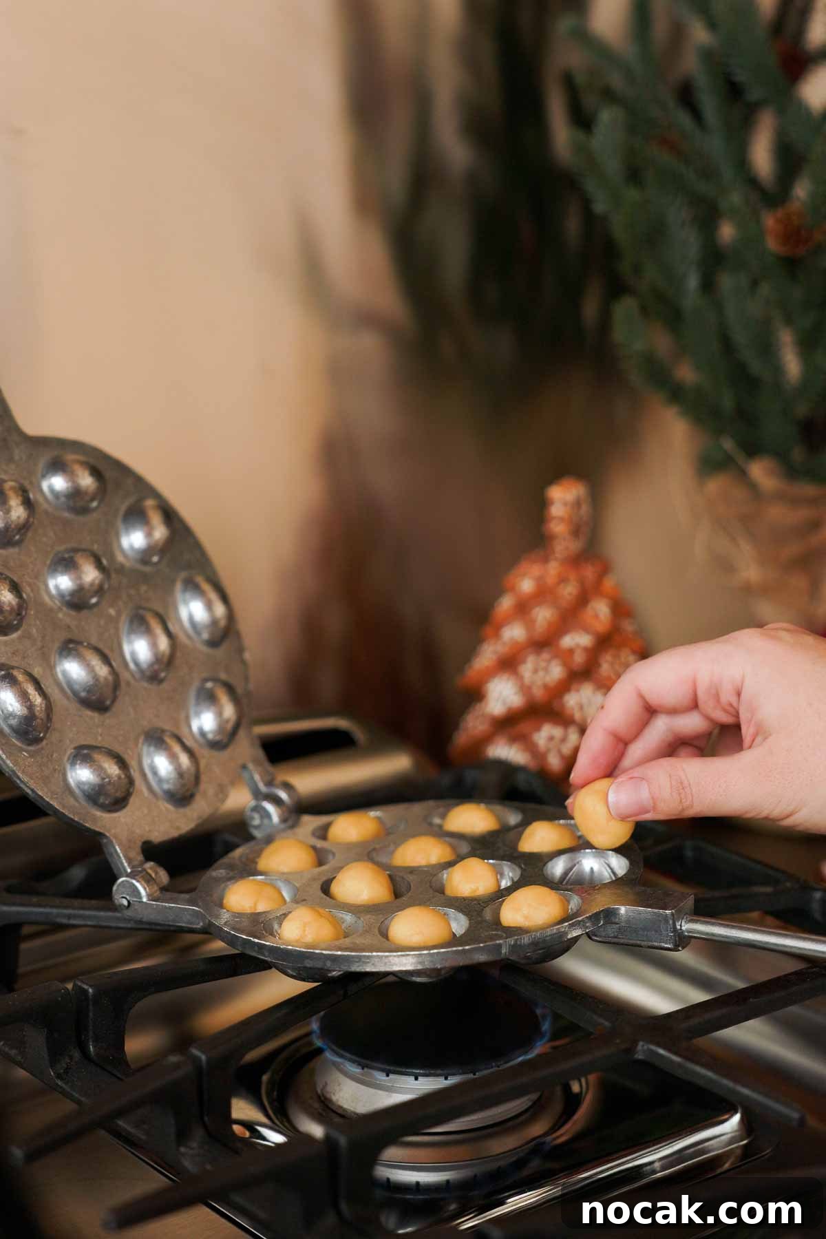 Oreshki Walnut Cookies Recipe — Russian Fillable Pastry Treats 9 placing balls of cookie dough into oreshki walnut cookie mold