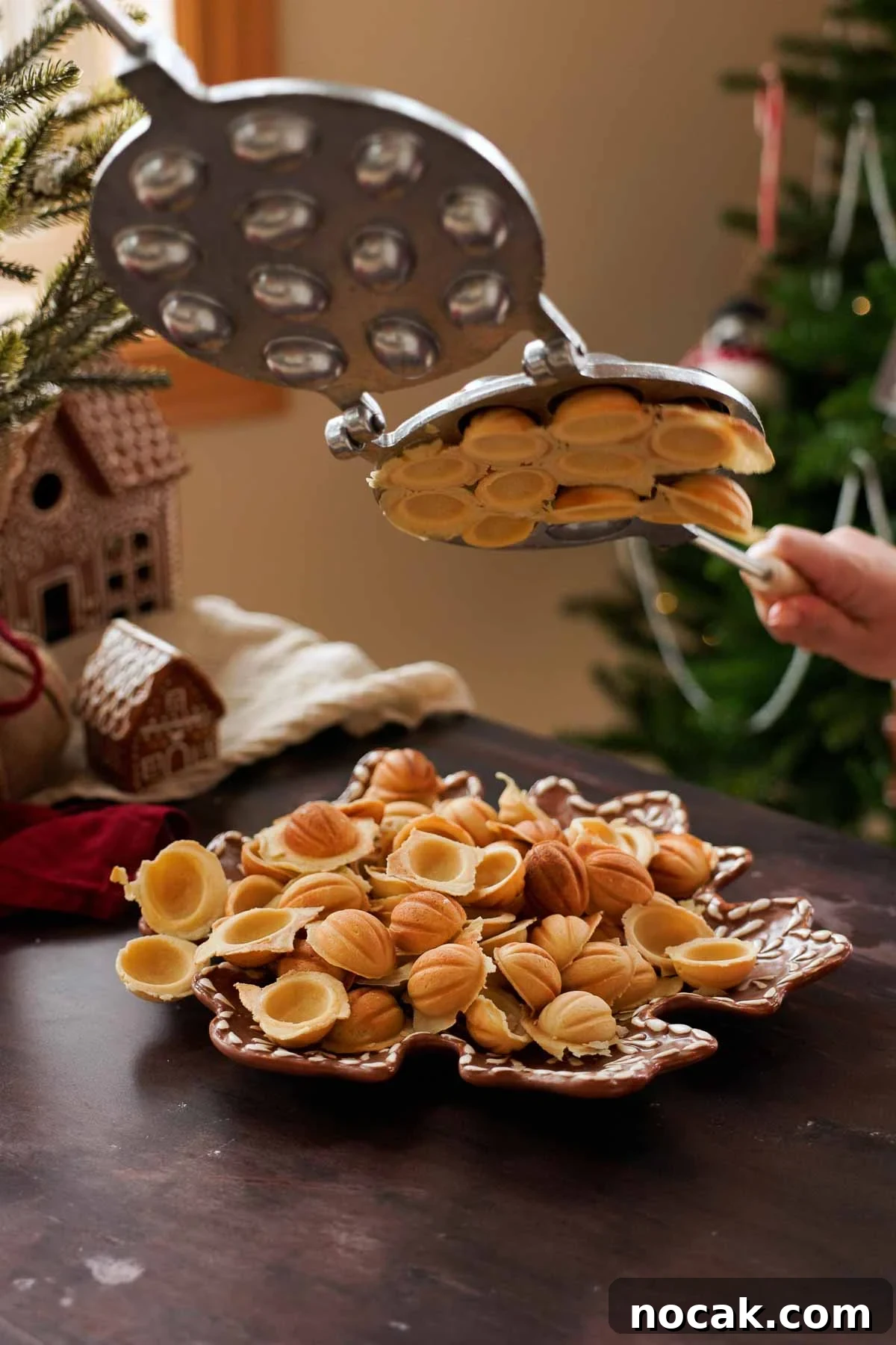 Oreshki Walnut Cookies Recipe — Russian Fillable Pastry Treats 10 dumping freshly cooked walnut cookies out of the mold
