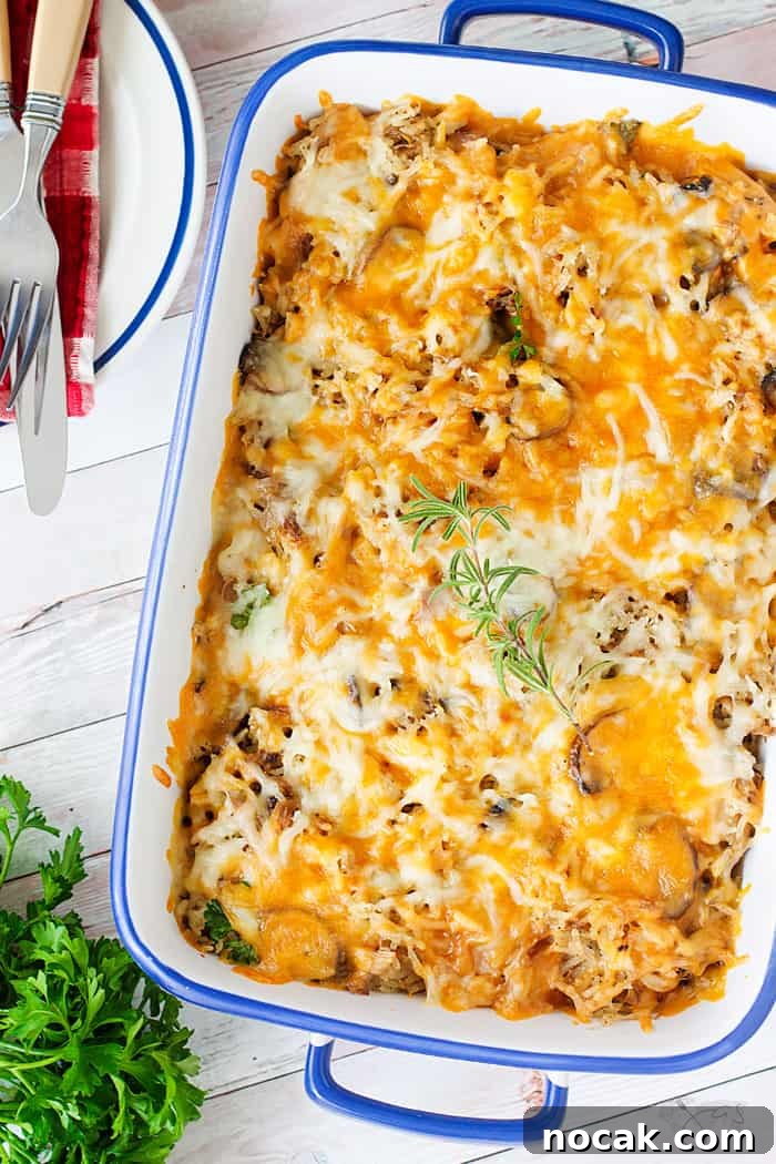 Cheesy Turkey Casserole Recipe for Leftovers | Jas' Kickasserole 4 A flat lay of the white dish with casserole with melted cheese on top