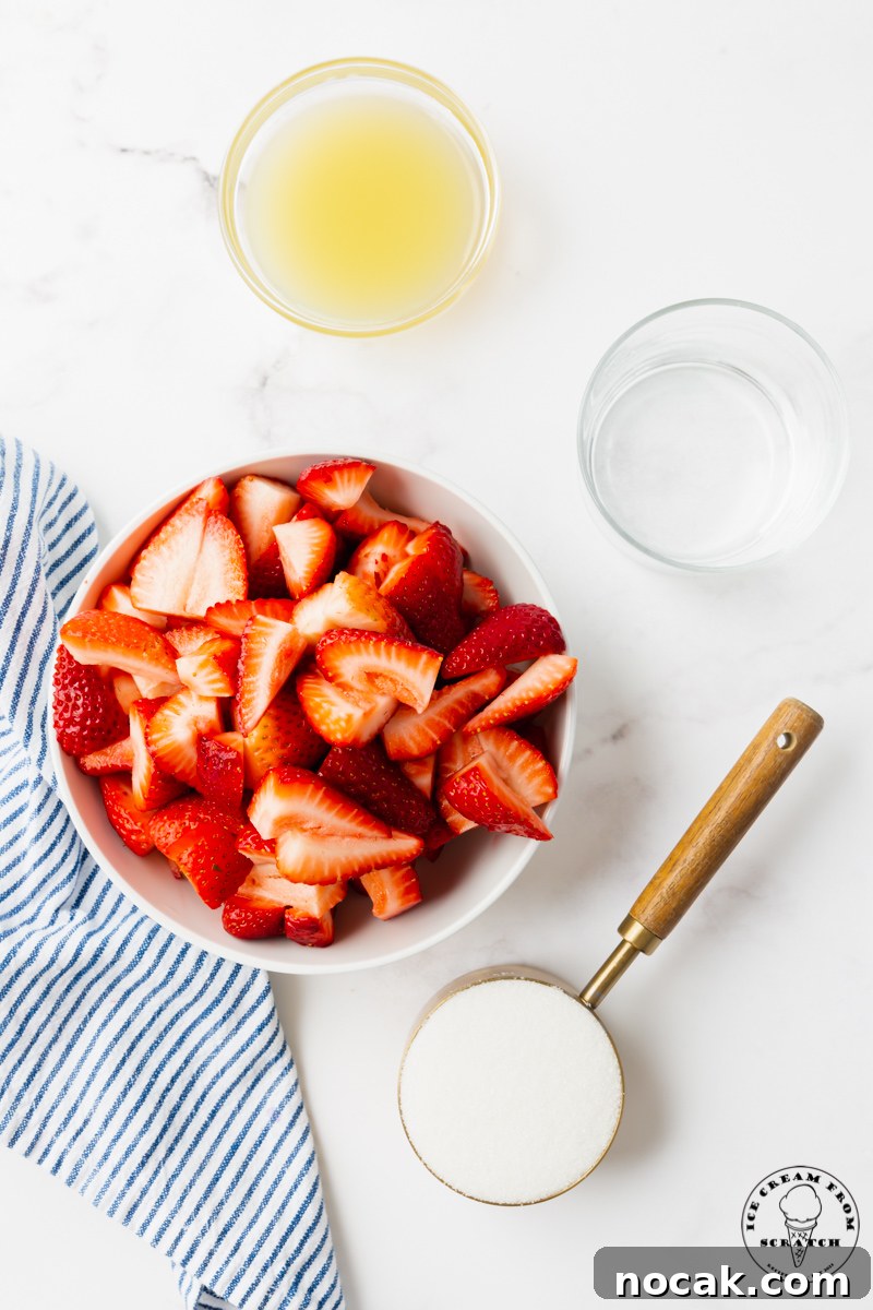 Homemade Strawberry Popsicles Recipe with Fresh Fruit 3 The ingredients needed to make strawberry popsicles, including berries, sugar, and lemon juice, measured into separate bowls, viewed from above.