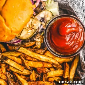 Homemade Ketchup Recipe: Simple from-Scratch Tomato Sauce 6 Homemade ketchup in a small glass jar next to a burger and some fries.