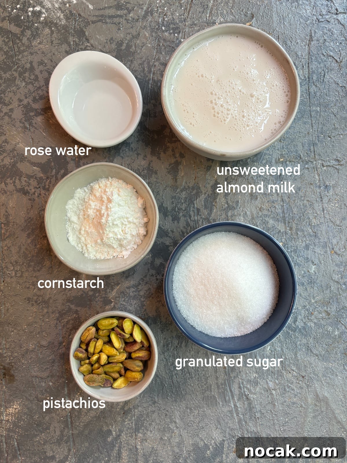 Malabi Rose Water Milk Pudding with Vegan Options 4 overhead image of the ingredients needed to make Malabi. Each ingredient is inside it's own small bowl.