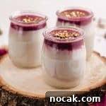 A close up view of 3 jars with malabi