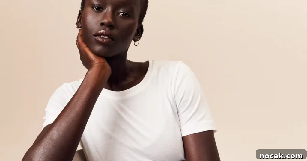 35 Ethical and Sustainable Loungewear Brands to Shop in 2024 17 A girl wearing a white t shirt with gold hoop earrings.