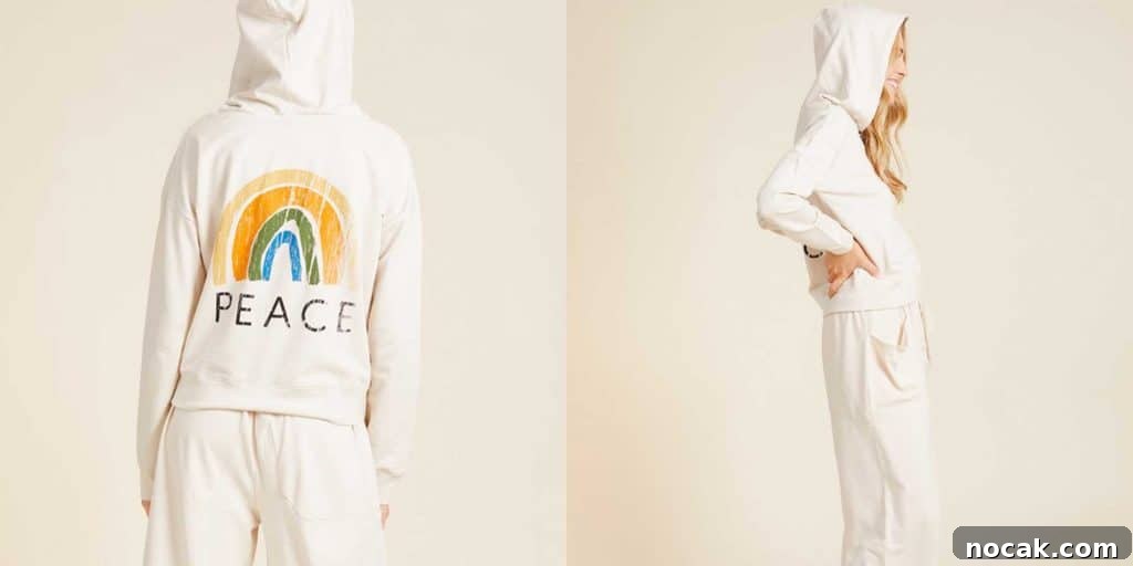 35 Ethical and Sustainable Loungewear Brands to Shop in 2024 8 A girl wearing a YesAnd hoodie that is white with a rainbow and the word 'peace' on the back.