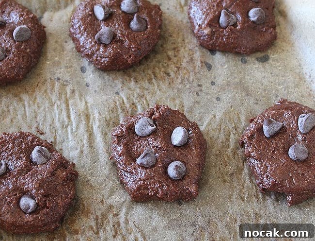 Fudgy Dark Chocolate Cookies — Nut Free Recipe 9 Unbaked cookies laid out on a baking sheet.
