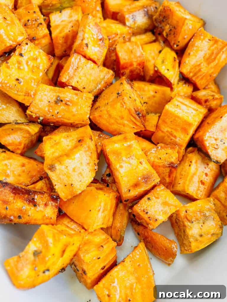 Maple-Glazed Roasted Sweet Potatoes with Crispy Edges 2 Maple roasted sweet potatoes topped with seasoning.