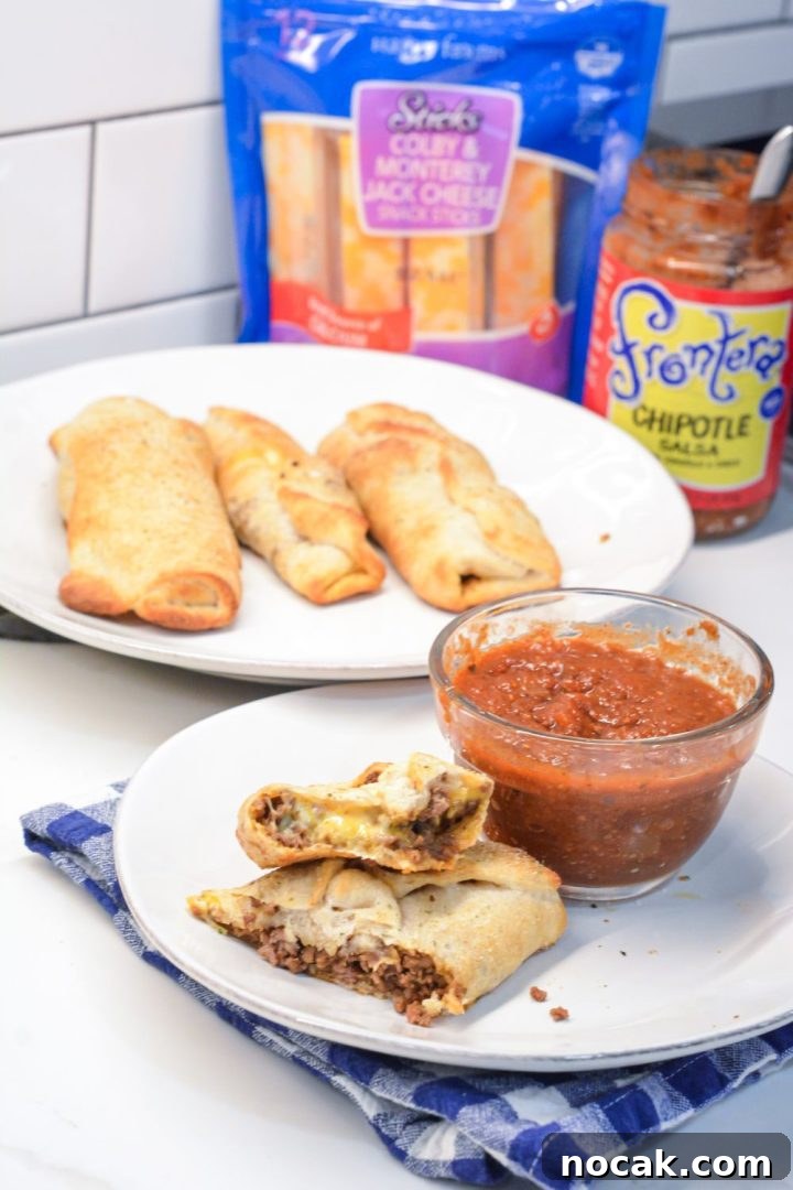 Crispy Taco Sticks Recipe: Flavorful Party Appetizers 2 Taco sticks are made by wrapping taco meat and a colby-jack cheese stick in pizza dough then baking for 10 minutes for an easy weeknight meal recipe.