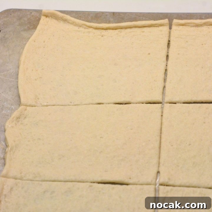 Crispy Taco Sticks Recipe: Flavorful Party Appetizers 5 Pop open the can of pizza dough and stretch the dough out on a baking sheet. Then cut into eight rectangle pieces.
