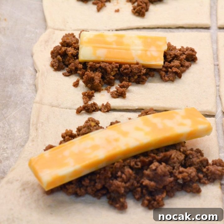 Crispy Taco Sticks Recipe: Flavorful Party Appetizers 6 Spoon the taco meat on the rectangles and then top with a cheese stick.