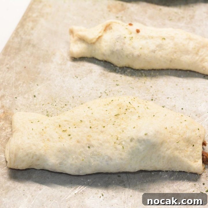 Crispy Taco Sticks Recipe: Flavorful Party Appetizers 7 Wrap the hamburger meat and cheese in the dough. The seam for the dough can be on the top or the bottom. Sprinkle garlic salt over the top of each taco stick.