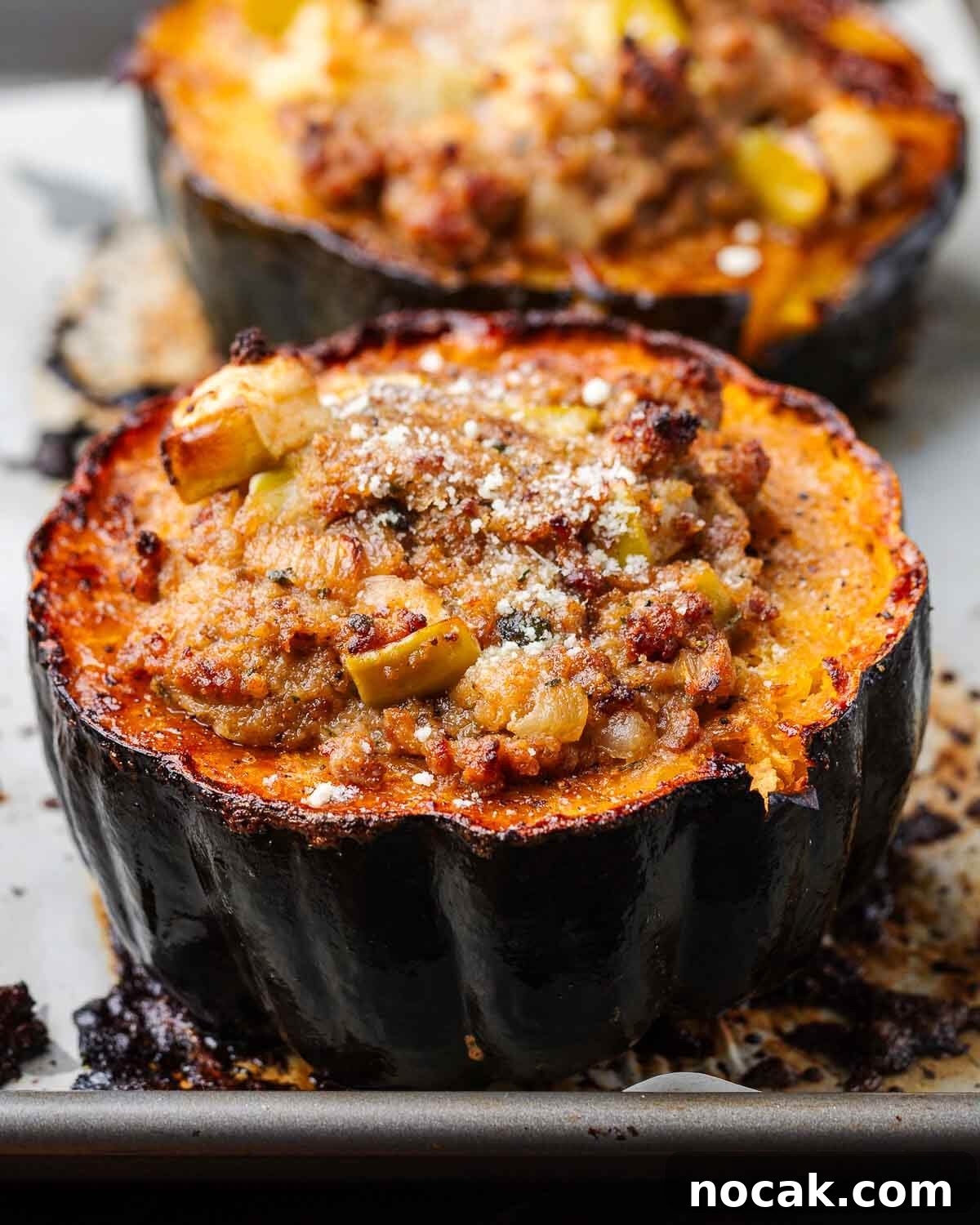 Sausage-Stuffed Acorn Squash Recipe for Cozy Fall Dinners 2 Sausage stuffed acorn squash on baking sheet.