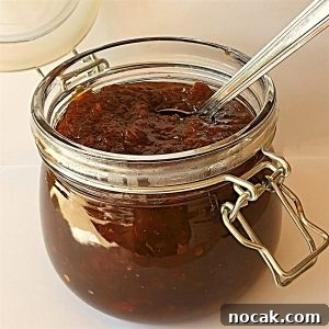 An open jar of Mrs Balls chutney with a spoon.