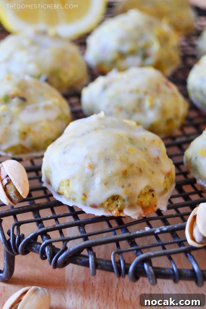 pistachio lemon cookie on a wire rack with a pistachio nut