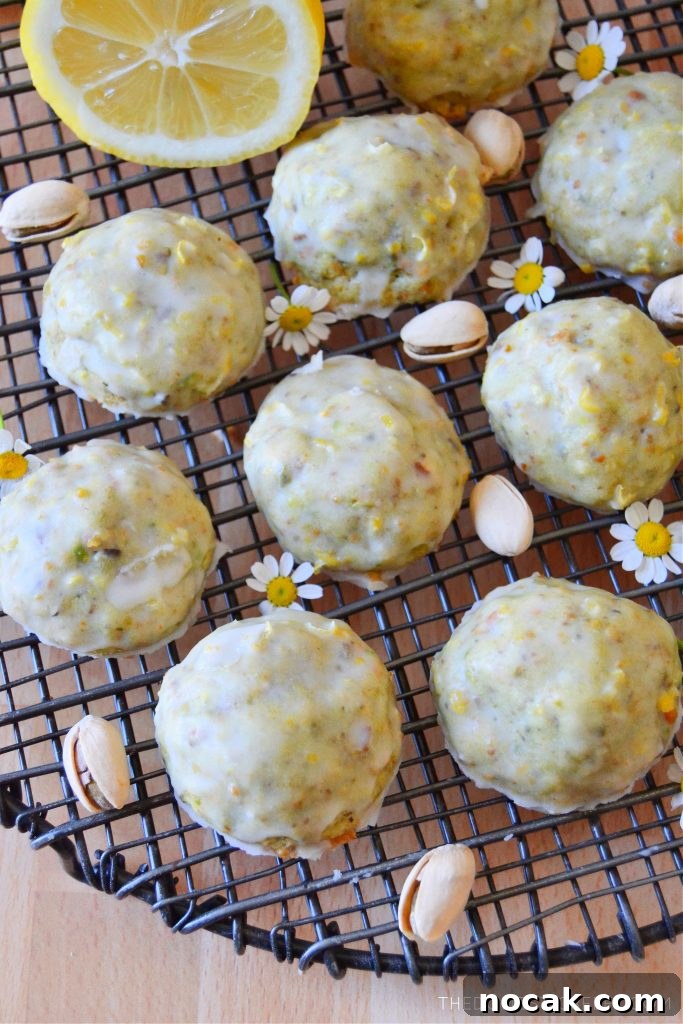 Pistachio Lemon Snowball Cookies Recipe for Zesty, Crunchy Treats 6 pistachio lemon cookies arranged on a wire rack with pistachios and daisies