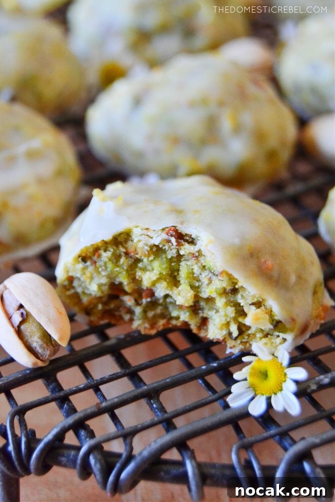 closeup of a pistachio lemon cookie with a bite missing