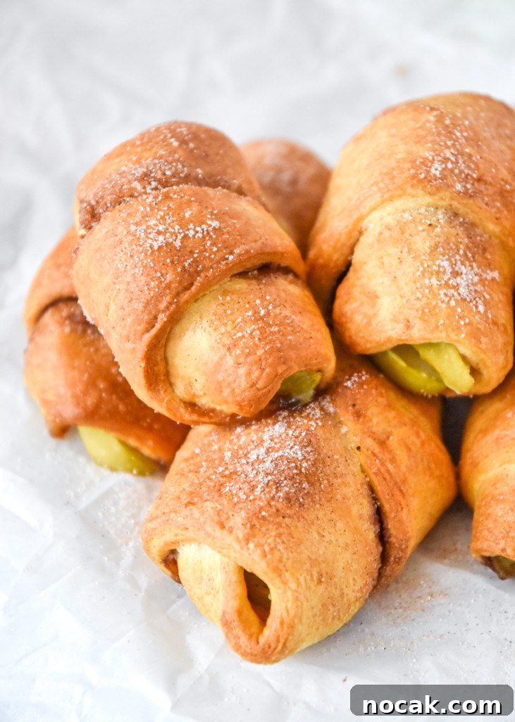 Air Fryer Apple Pie Crescent Rolls Recipe 10 air fryer apple pie crescent rolls stacked with cinnamon sugar on top.