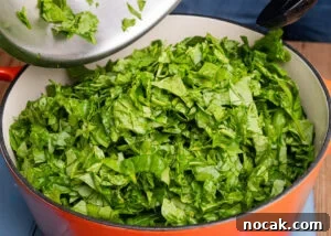 Saag Bhaji Recipe: Creamy Indian Spinach Curry with Spices 9 Chopped spinach added to the cooking pot