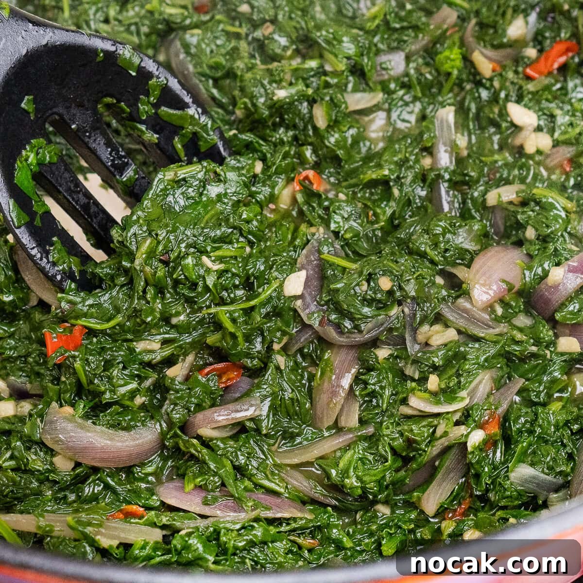 Saag Bhaji Recipe: Creamy Indian Spinach Curry with Spices 22 Sag Bhaji being stirred together with a spoon