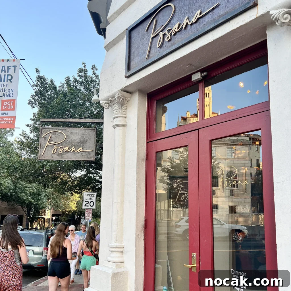 Street view of the Posana restaurant entrance with red-framed glass doors.